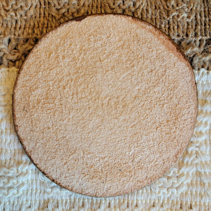 Back view of handmade starburst-edge leather drink coaster – Rocking Y Forge and Leather