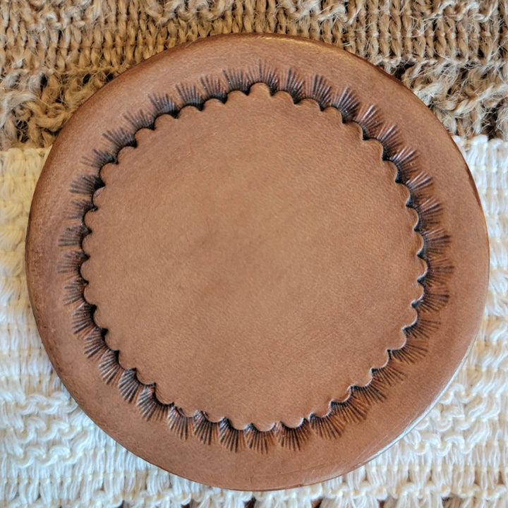 Front view of handmade starburst-edge leather drink coaster – Rocking Y Forge and Leather