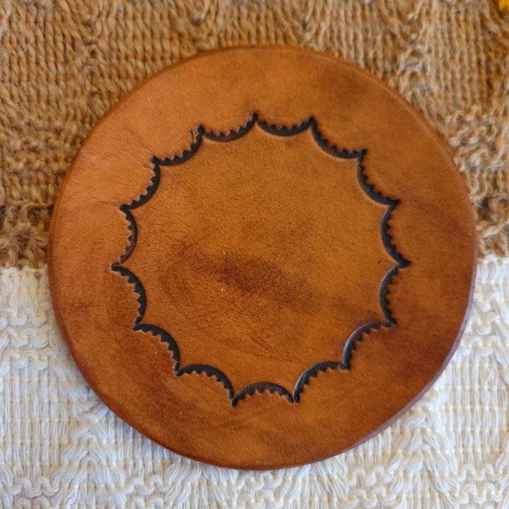 Single leather coaster for sale in medium brown stain with inward scalloped border design.