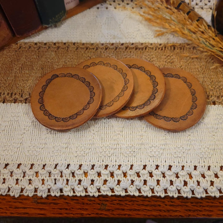 Set of 4 handmade leather coasters with a half daisy design