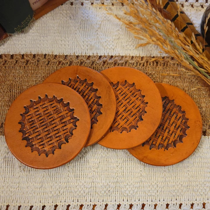 Set of 4 handmade leather coasters with an inverted starburst and basketweave design