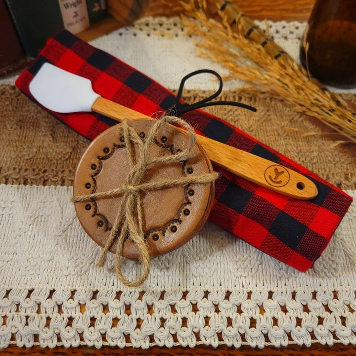 western gift set with handmade (scallop valley dot) leather coasters, white mini-spatula, and red/black plaid towel