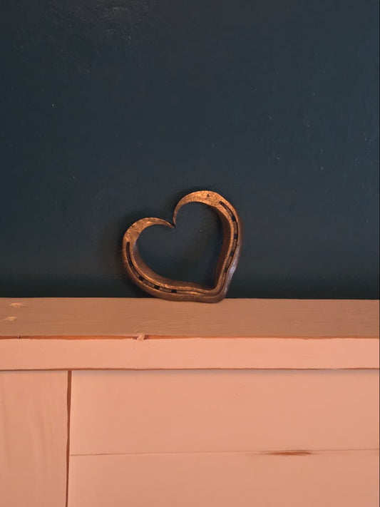 handmade horseshoe heart setting on a wooden headboard